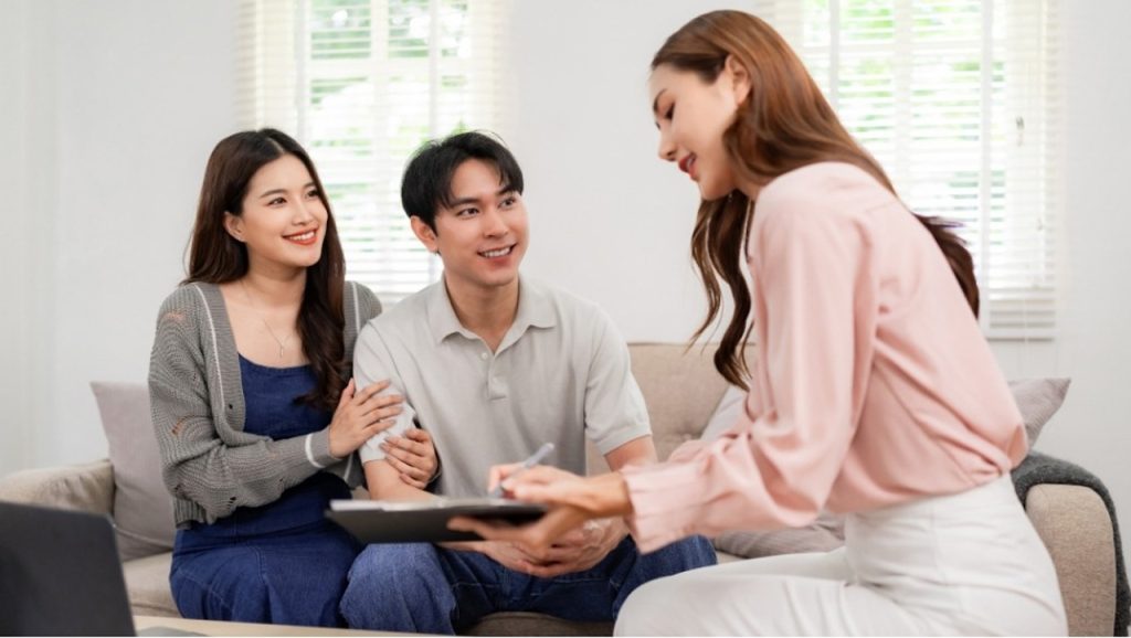 A happy couple consulting with a specialist about affordable options for cardiology care in Houston, TX for the family.