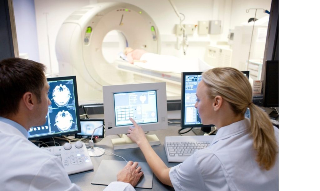 Technologists monitoring discounted & low-cost diagnostic imaging in Houston to ensure accurate medical results.