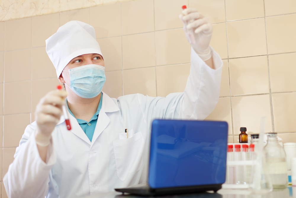 Research worker holding blood test tubes at a center for discounted & low-cost lab tests in Houston, Texas