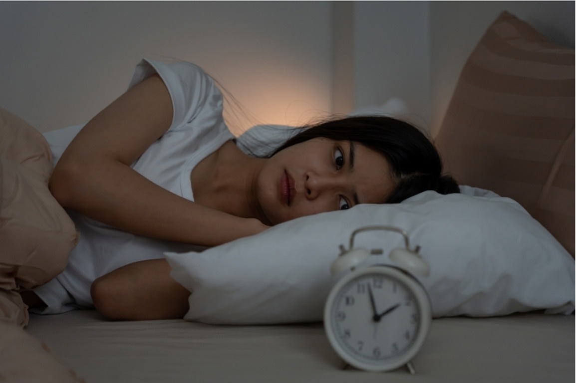 Woman awake at night needing specialized psychiatry consultations care in Houston, TX for sleep and anxiety issues.