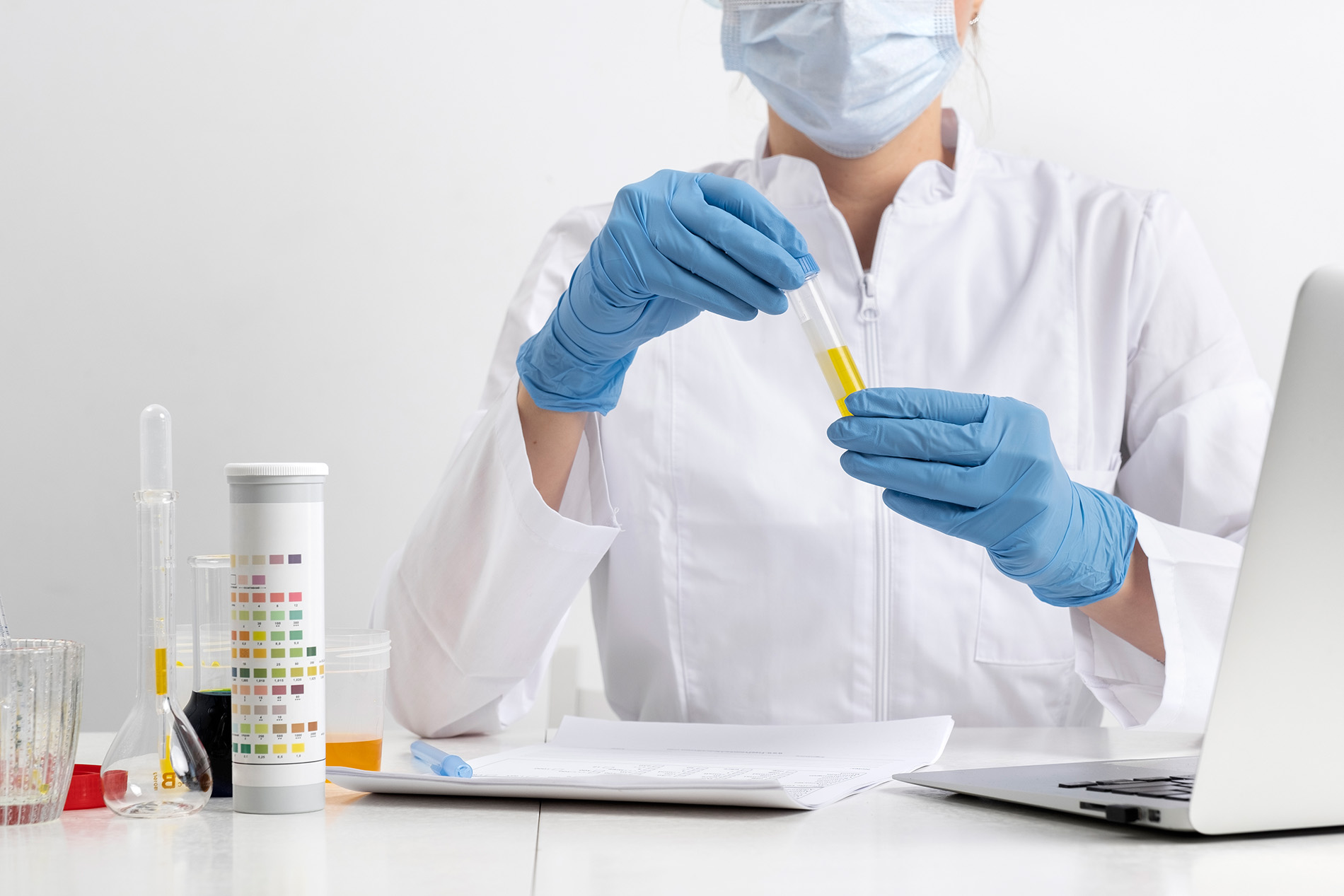 A medical lab technician conducts a urine sample analysis as part of professional on-site testing and procedures.