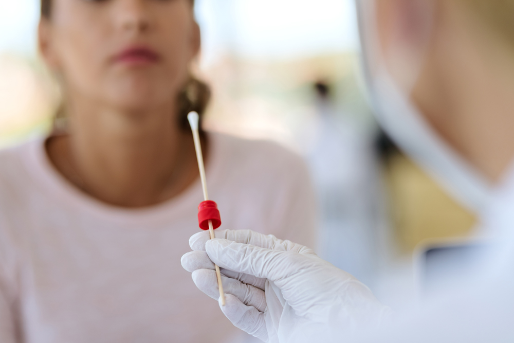 Healthcare worker performing a PCR swab test at a clinic for discounted & low-cost lab tests in Houston TX.