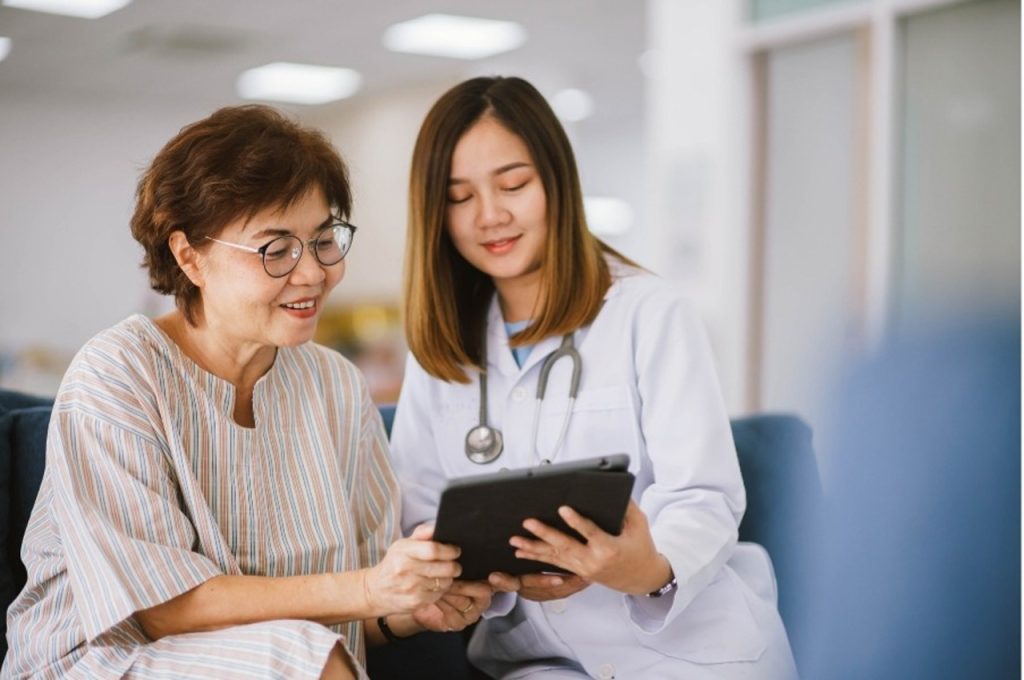 Medical professional discussing digital health records for preventive and wellness care in Houston with a female patient