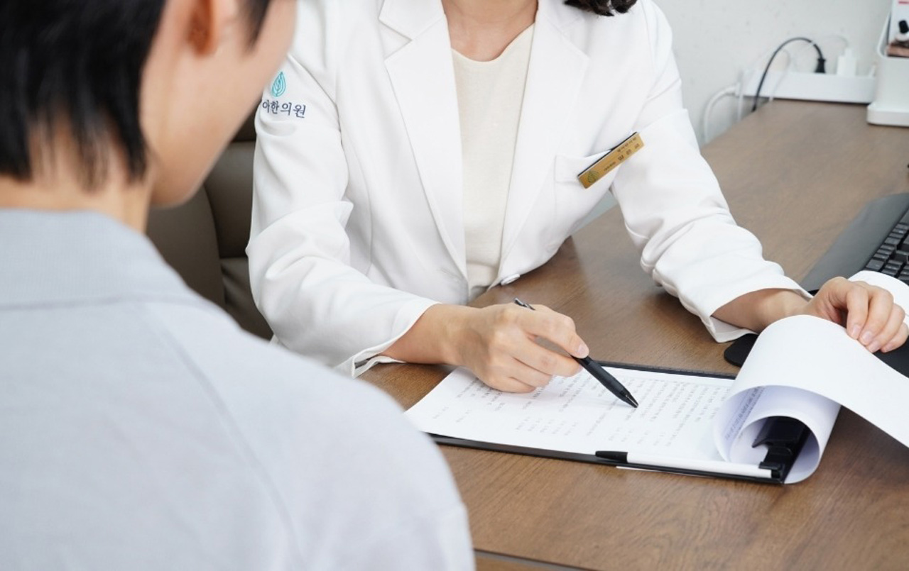 Close up of a clinician reviewing health records during a preventive & wellness care Houston office appointment