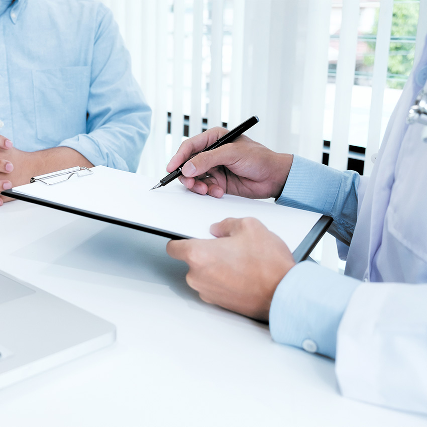 A professional doctor consulting with a patient during a high-quality Annual & Work Physicals Houston TX appointment.